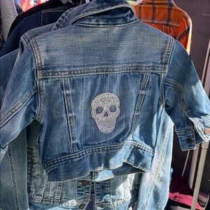 Light Blue Cropped Jean Jacket with Distressing and Skull Design